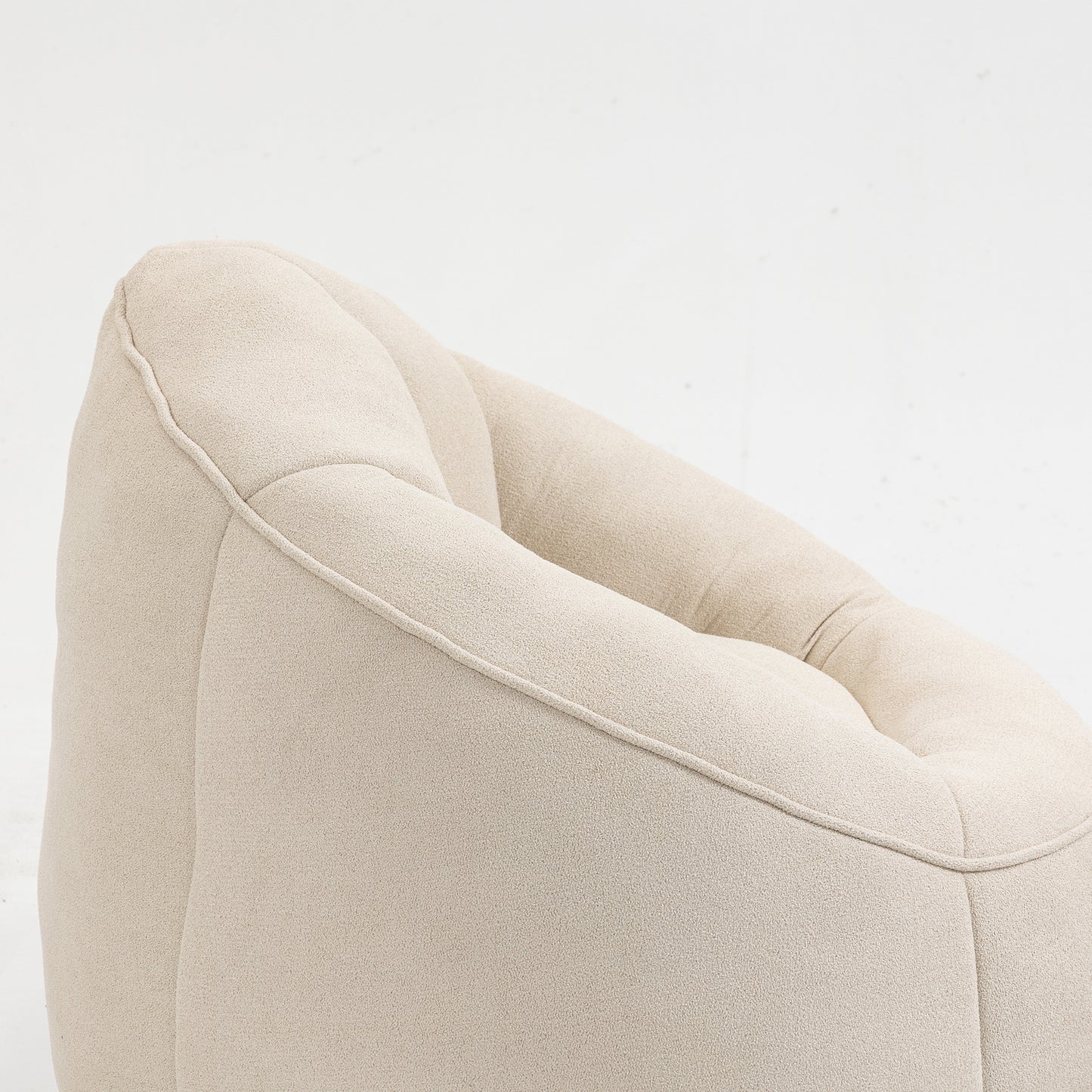 Cream boucle armchair with detailed stitching and deep tufting for comfort