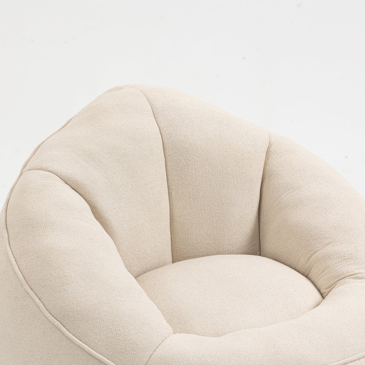 Plush cream boucle accent chair with rounded channeltufted back and seat for cozy living rooms