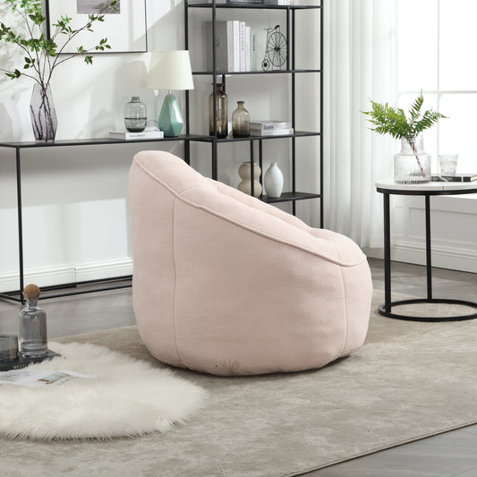 Soft pink boucle bean bag chair for relaxed seating in a modern living room