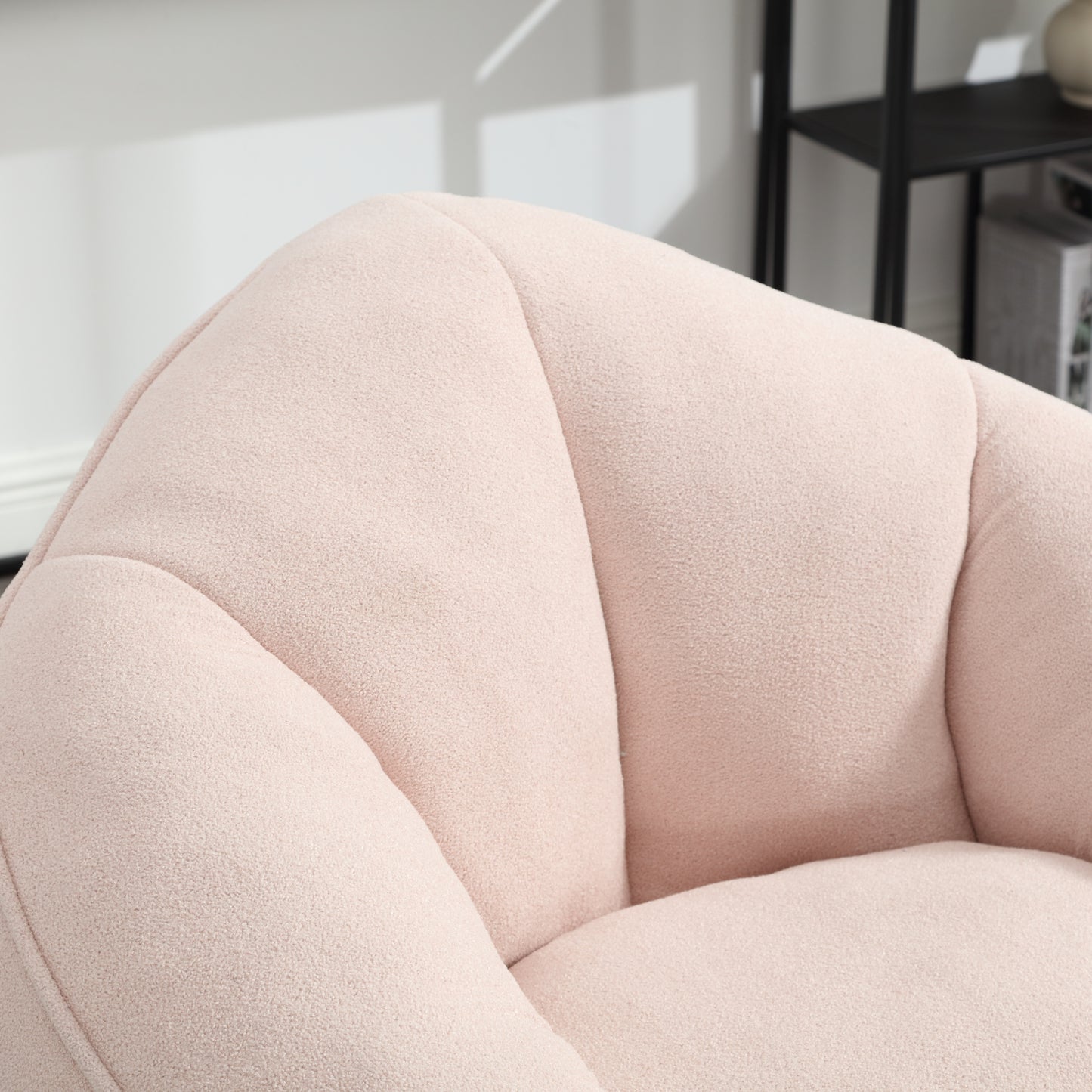 Closeup of plush pink boucl fabric accent chair with channel tufting detail