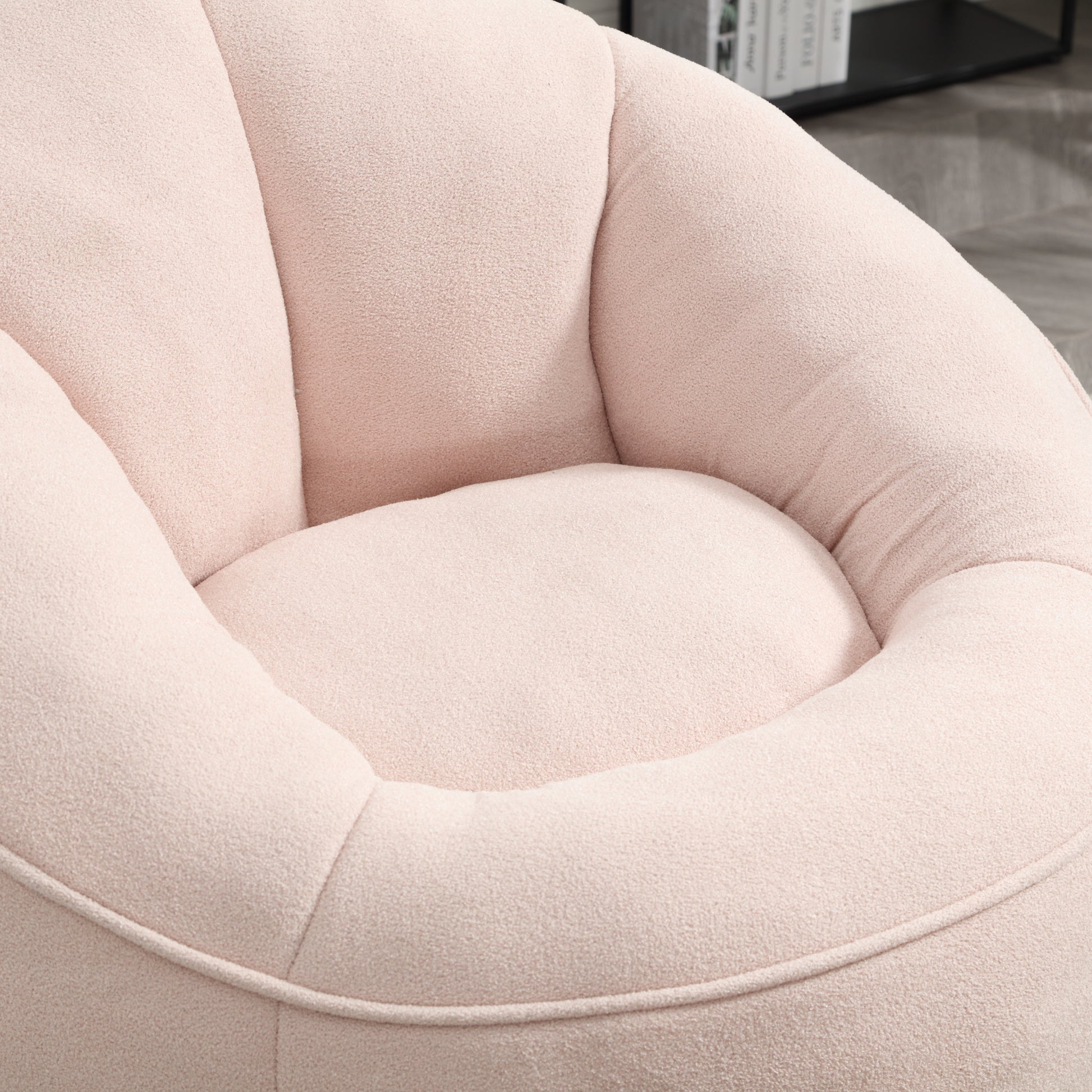 Plush pink accent chair with channel tufting and a curved silhouette