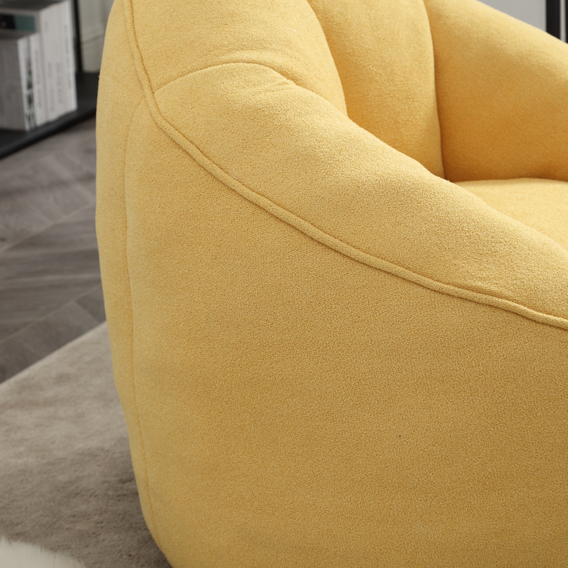 Plush yellow armchair with curved seams perfect for a cozy living room accent