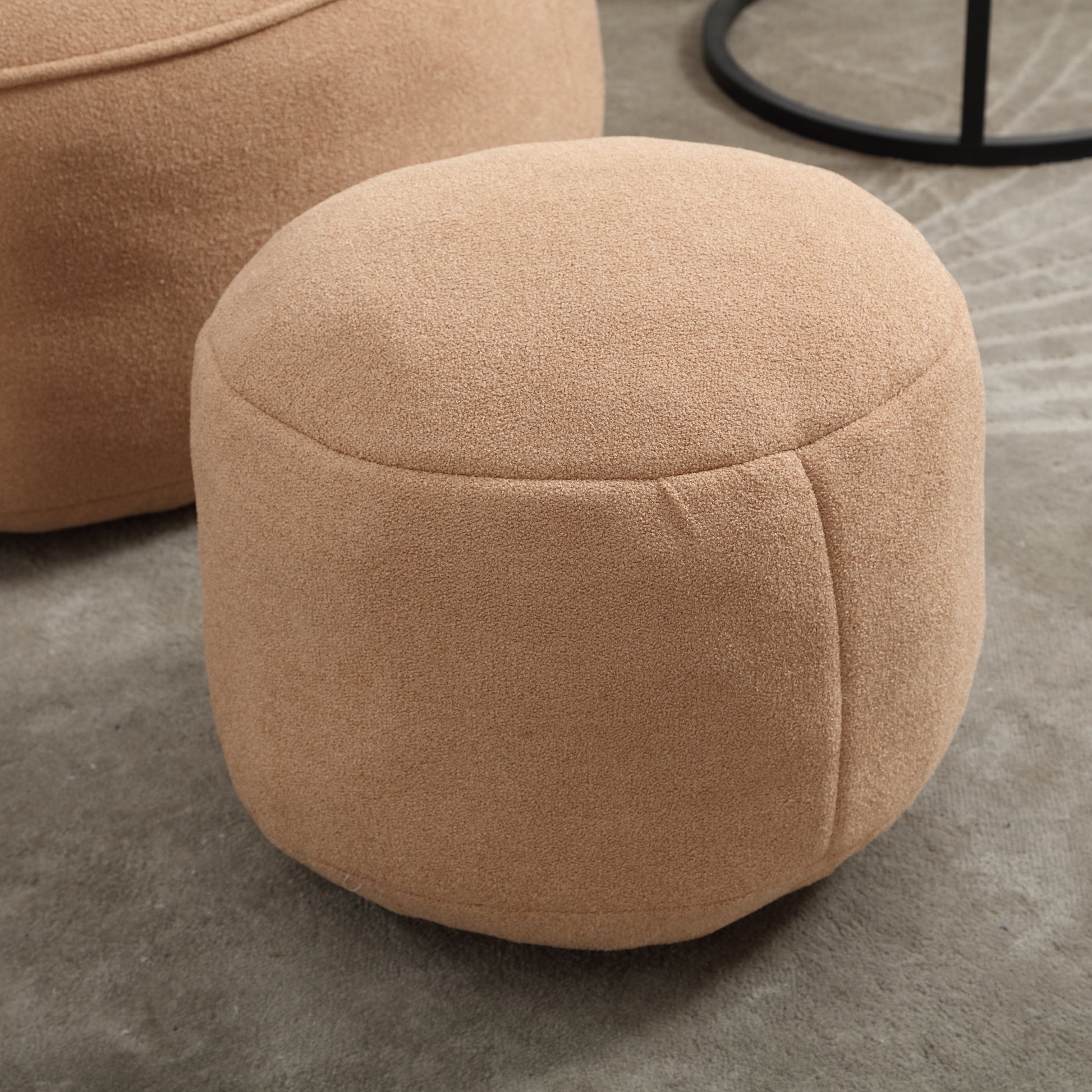 Round beige boucle fabric ottoman with stitching details