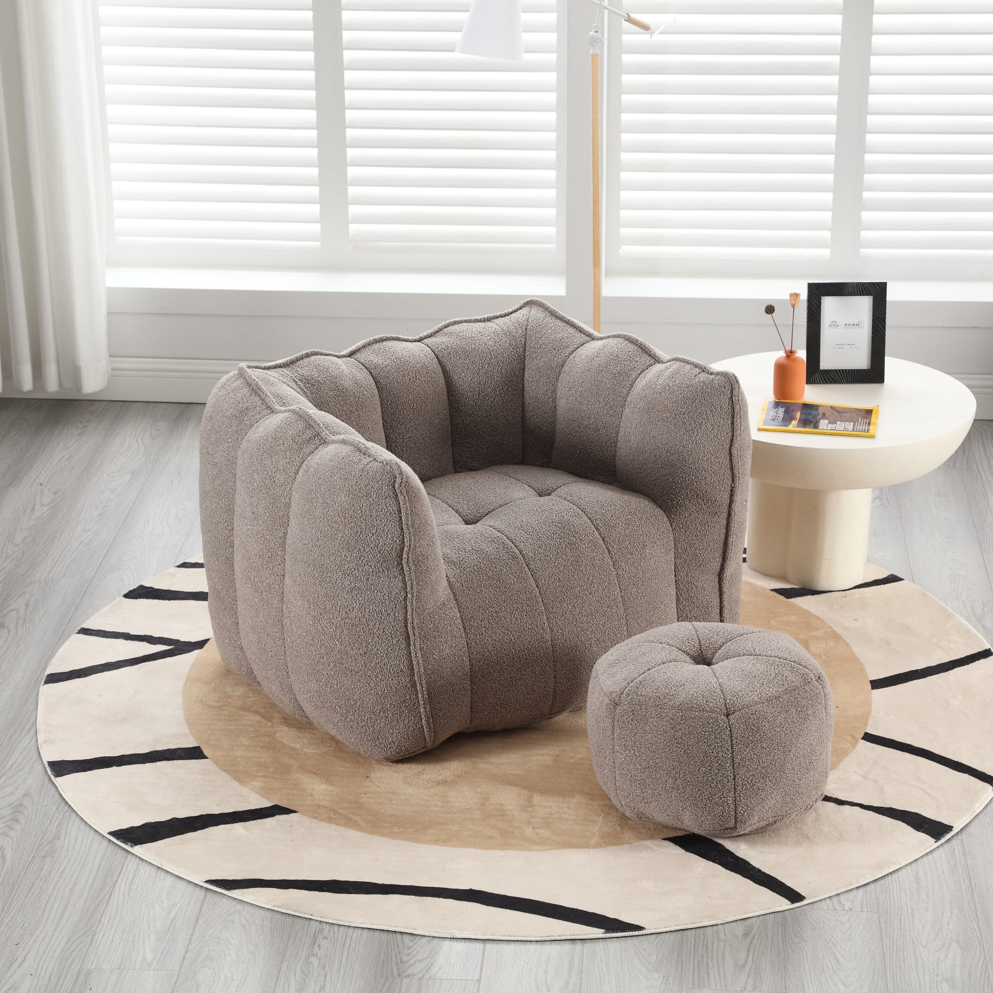 Plush boucle armchair with scalloped back and matching ottoman in taupe