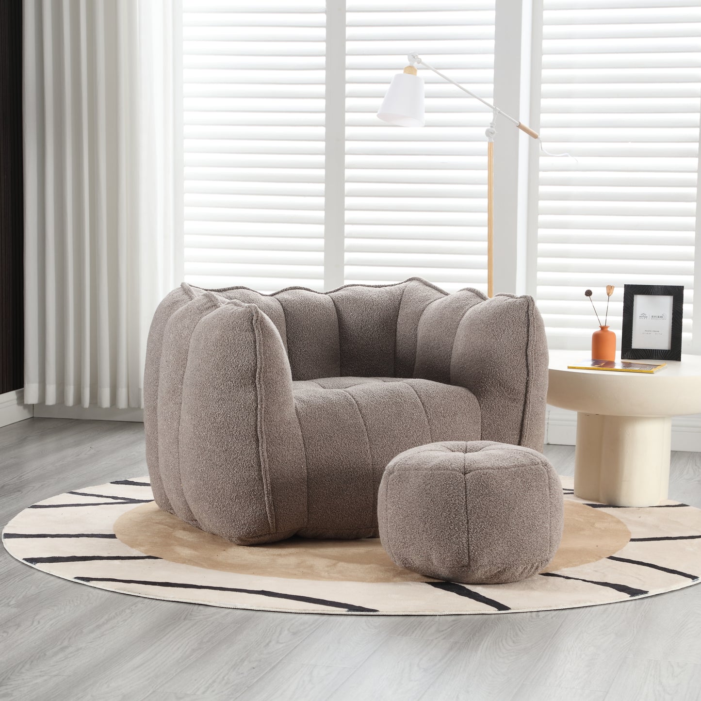 Plush taupe accent chair with unique fluted design and matching ottoman