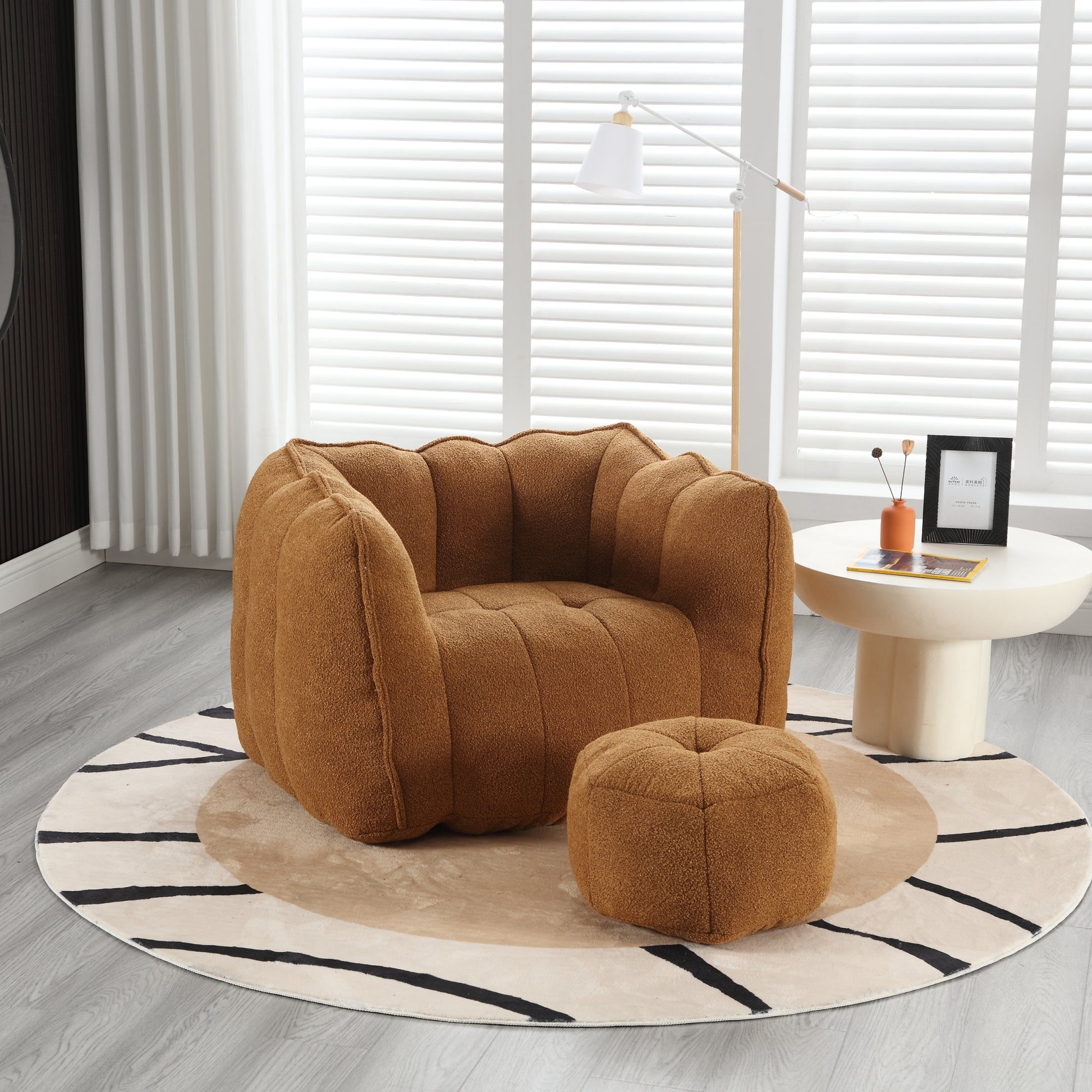 Brown boucle armchair with a matching ottoman featuring channel tufting and a plush texture