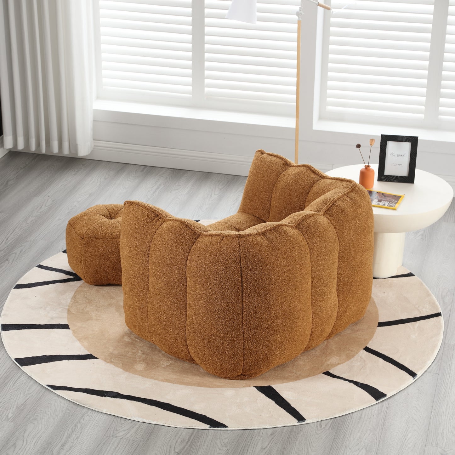 Cozy boucle fabric accent chair in warm brown with matching ottoman for a modern living room