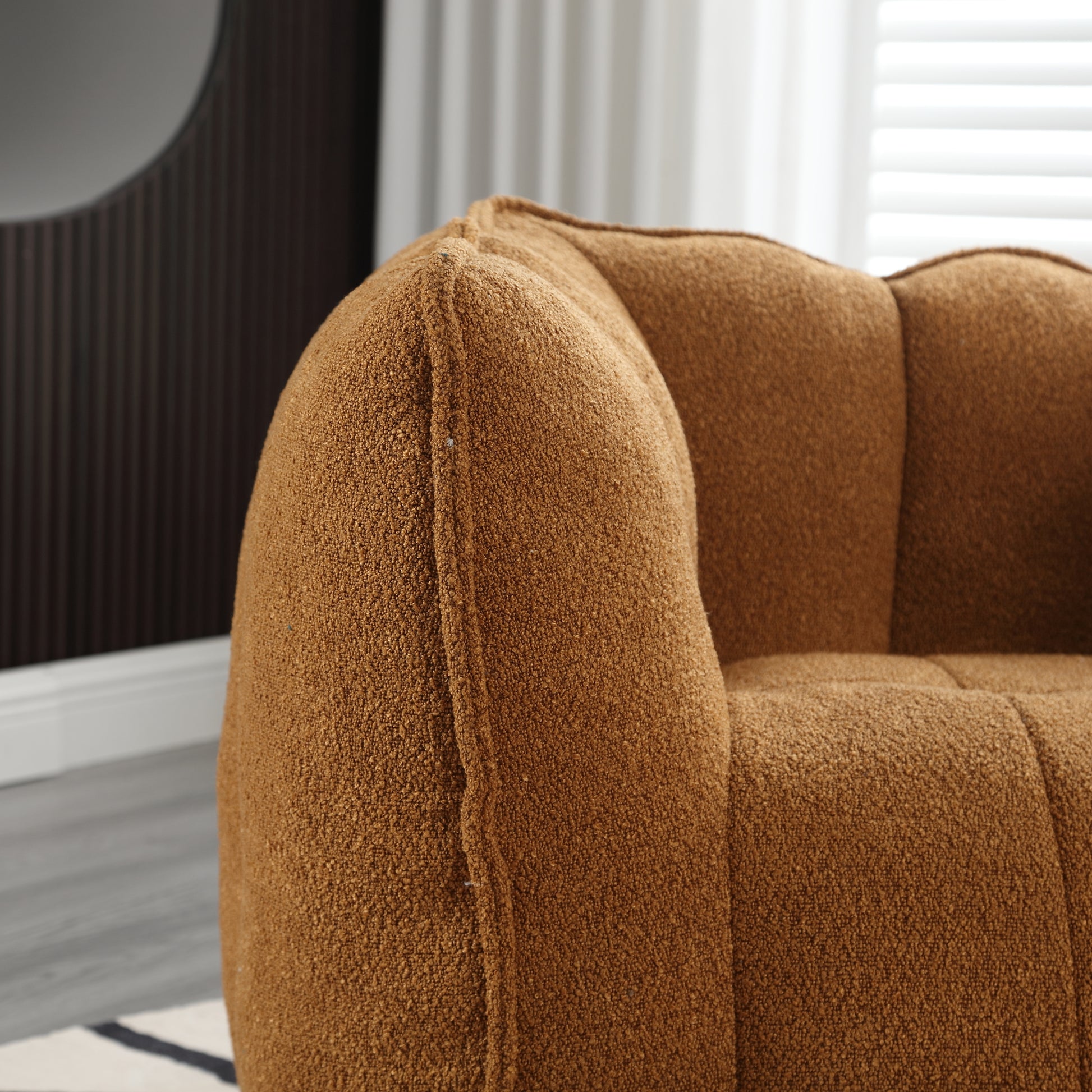 Closeup of a plush rustcolored armchair with channel tufting perfect for a cozy living room