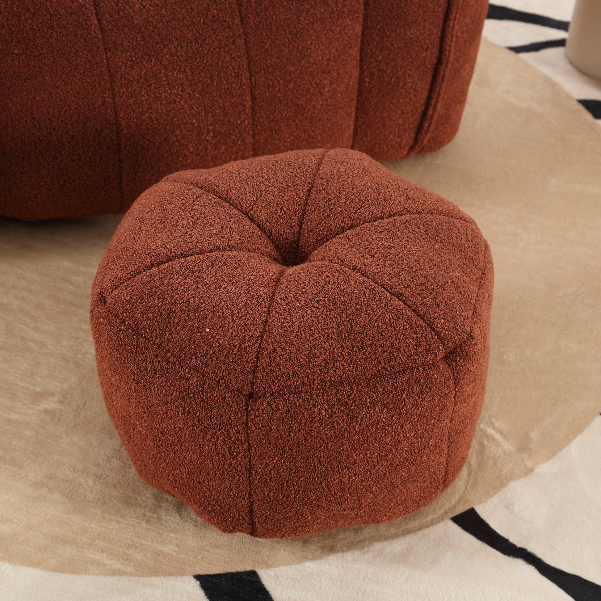 Textured terracotta round ottoman with tufted top for living room seating