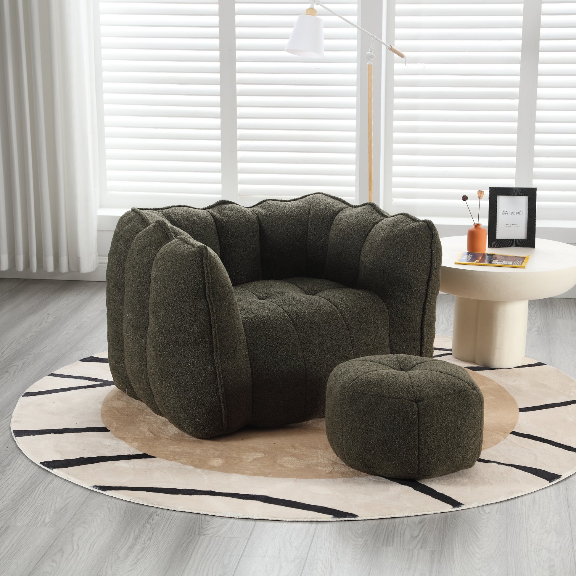 Dark green boucl armchair with channeled upholstery and matching ottoman contemporary style