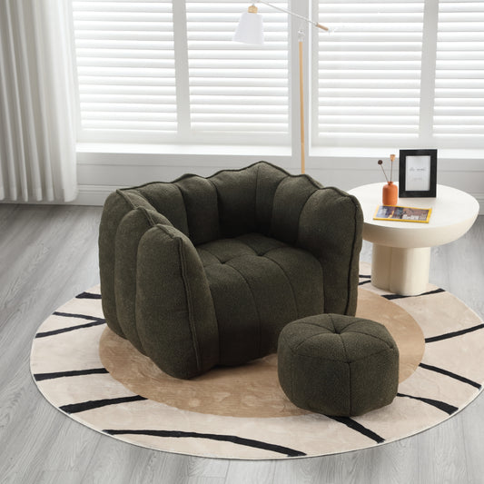 Dark green textured armchair with piped edges and matching ottoman for cozy living room seating
