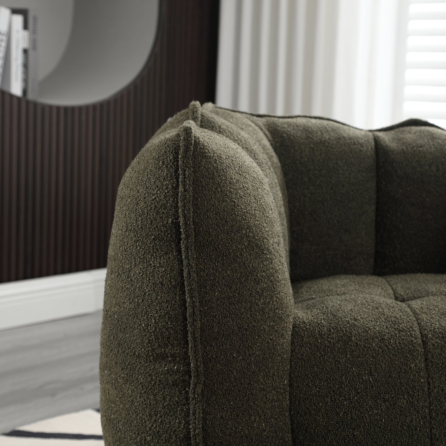 Textured dark green boucle fabric armchair with deep button tufting