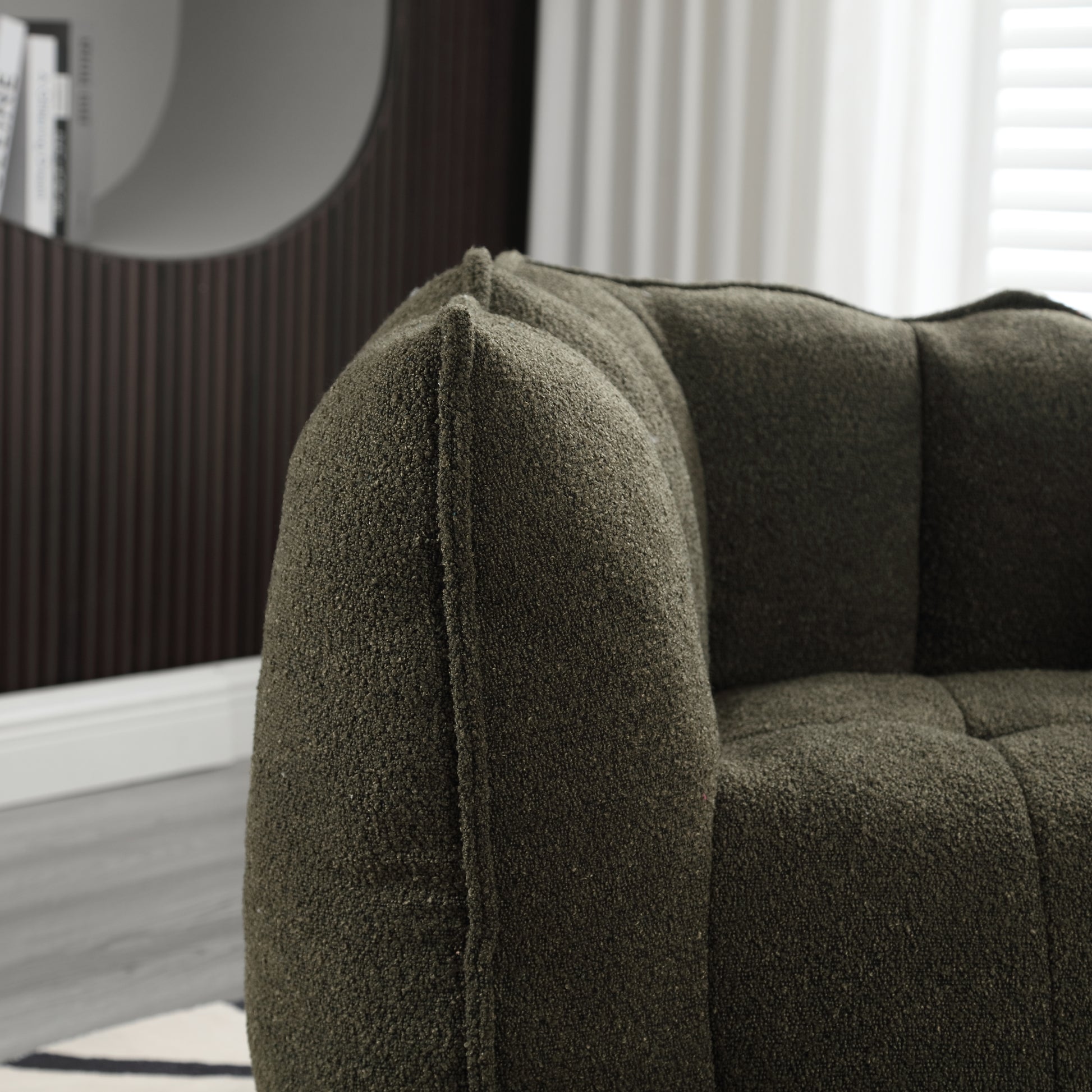 Textured dark green boucle fabric armchair with deep button tufting