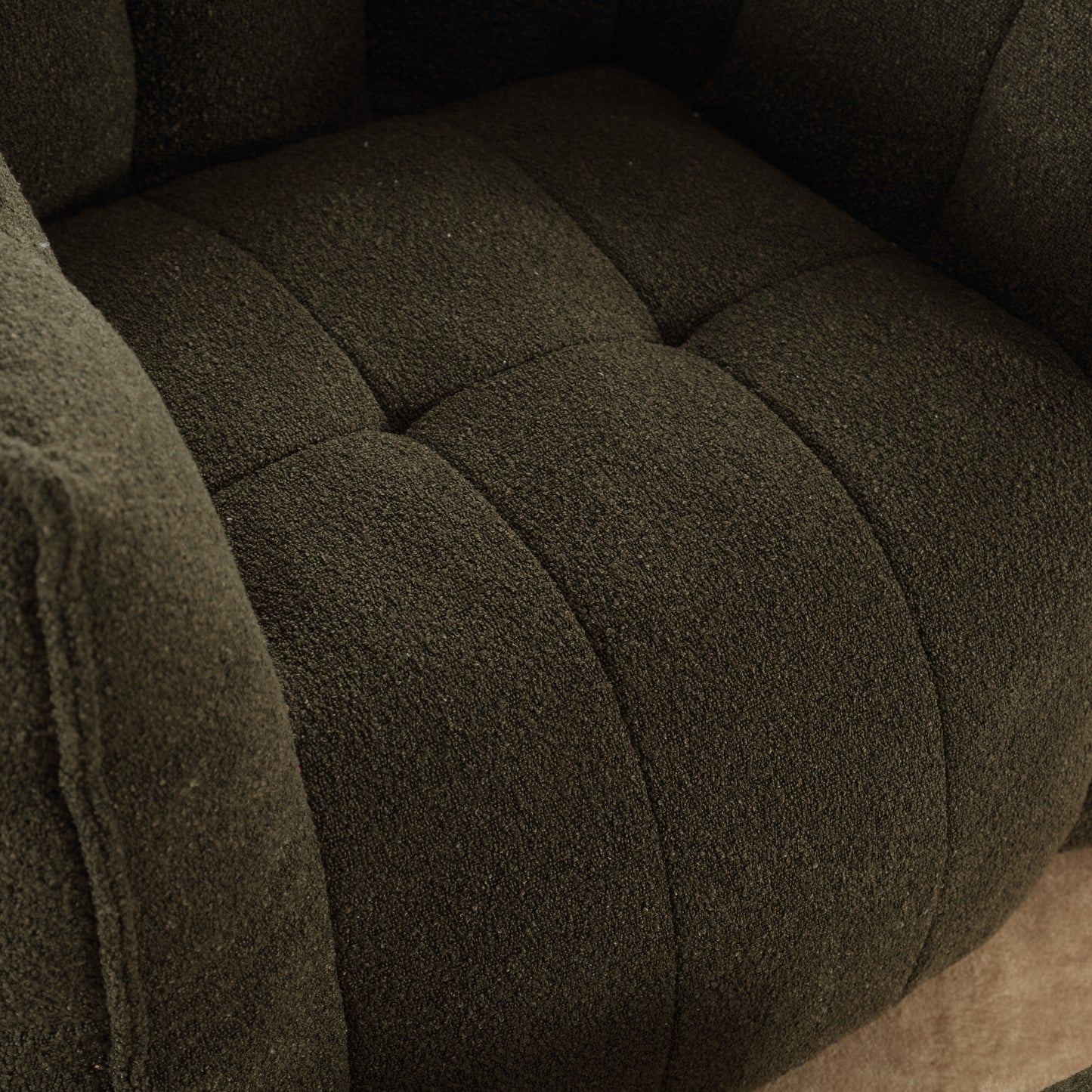 Tufted dark green boucle armchair cushion with textured fabric detail