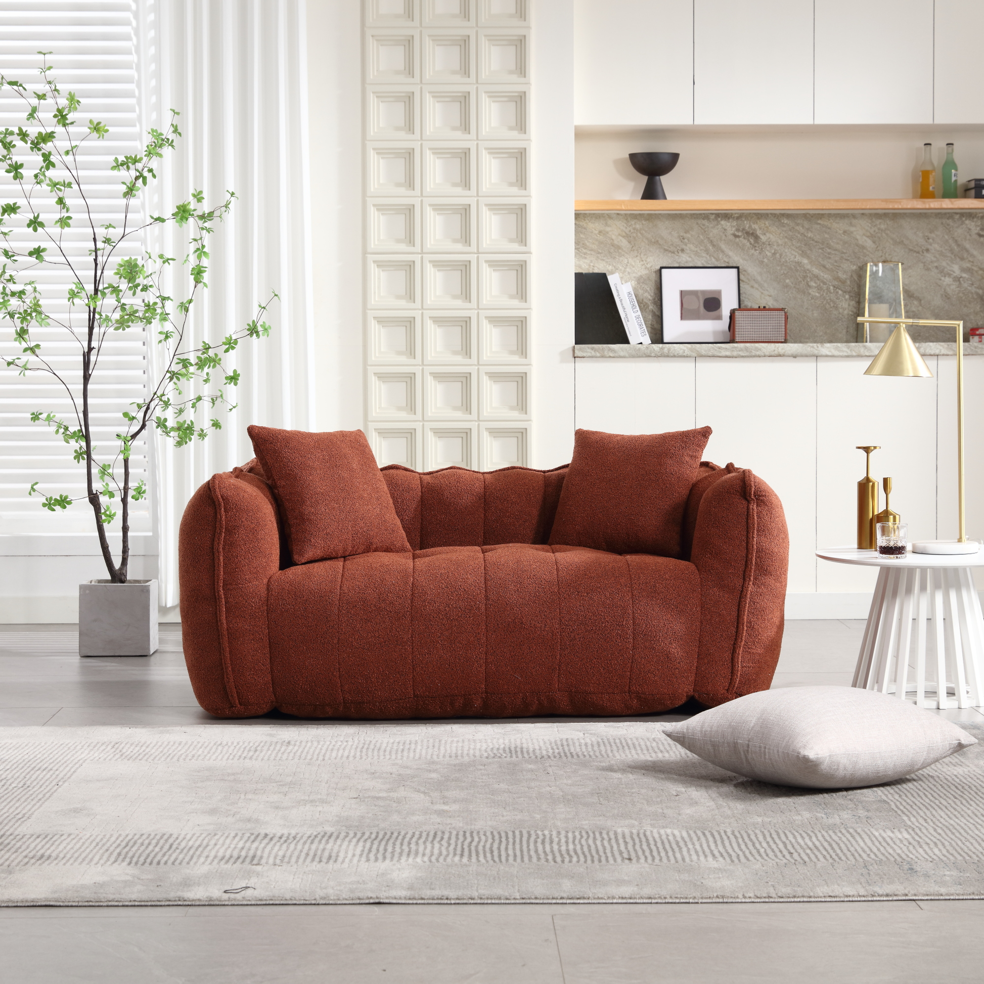 Plush terracotta boucle loveseat with rounded arms and two accent pillows