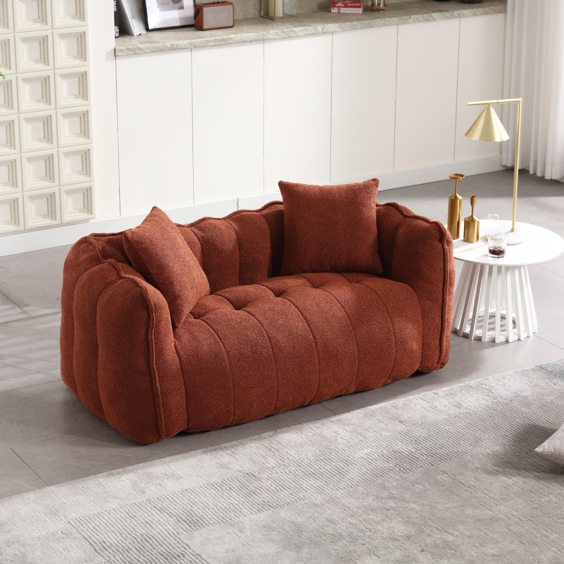 Plush terracotta boucl loveseat with channel tufting and matching throw pillows