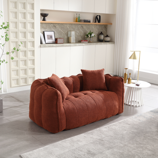Terracotta boucle fabric sofa with plush cushions and tufted seat