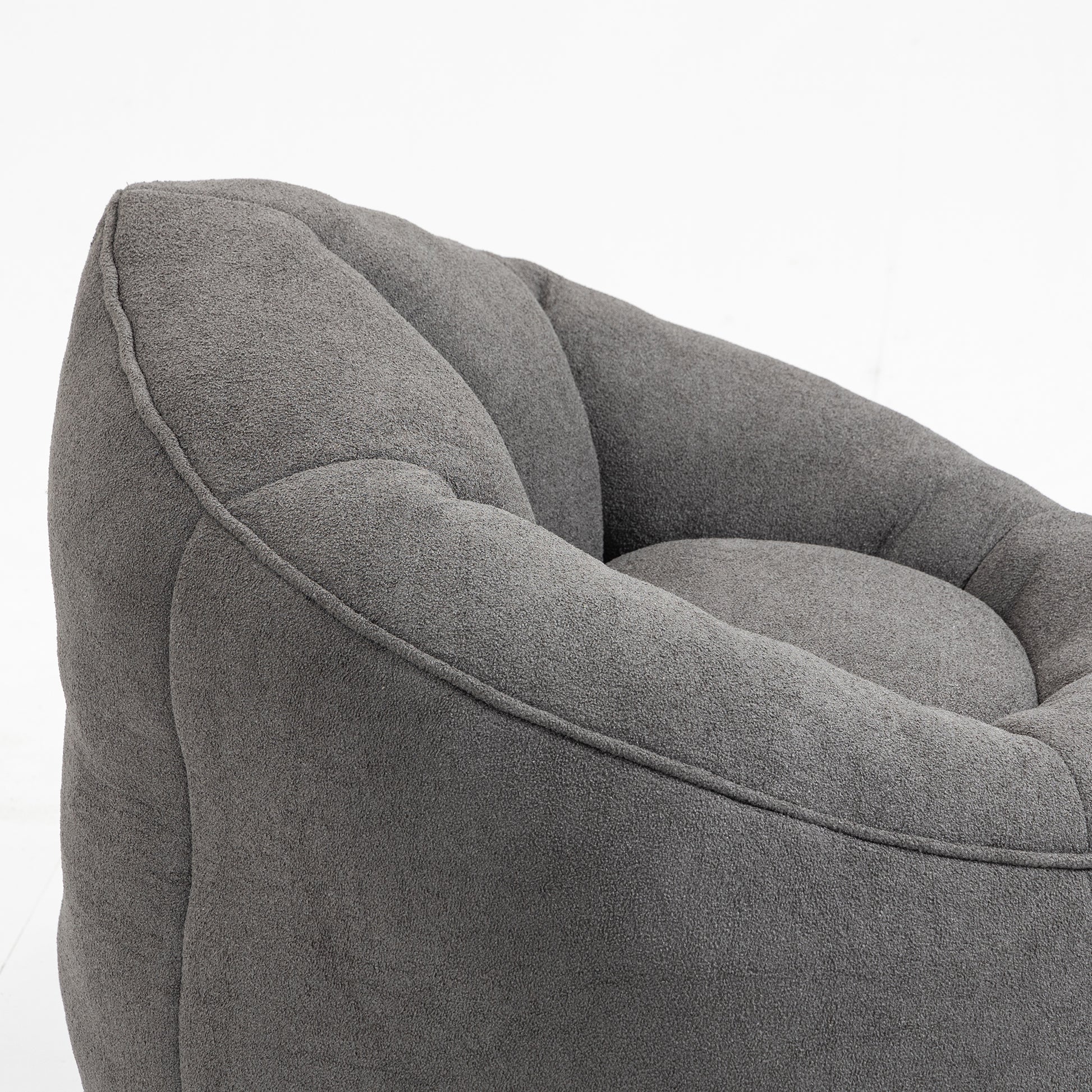 Closeup of a plush grey bean bag chair with deep channel tufting perfect for modern living spaces