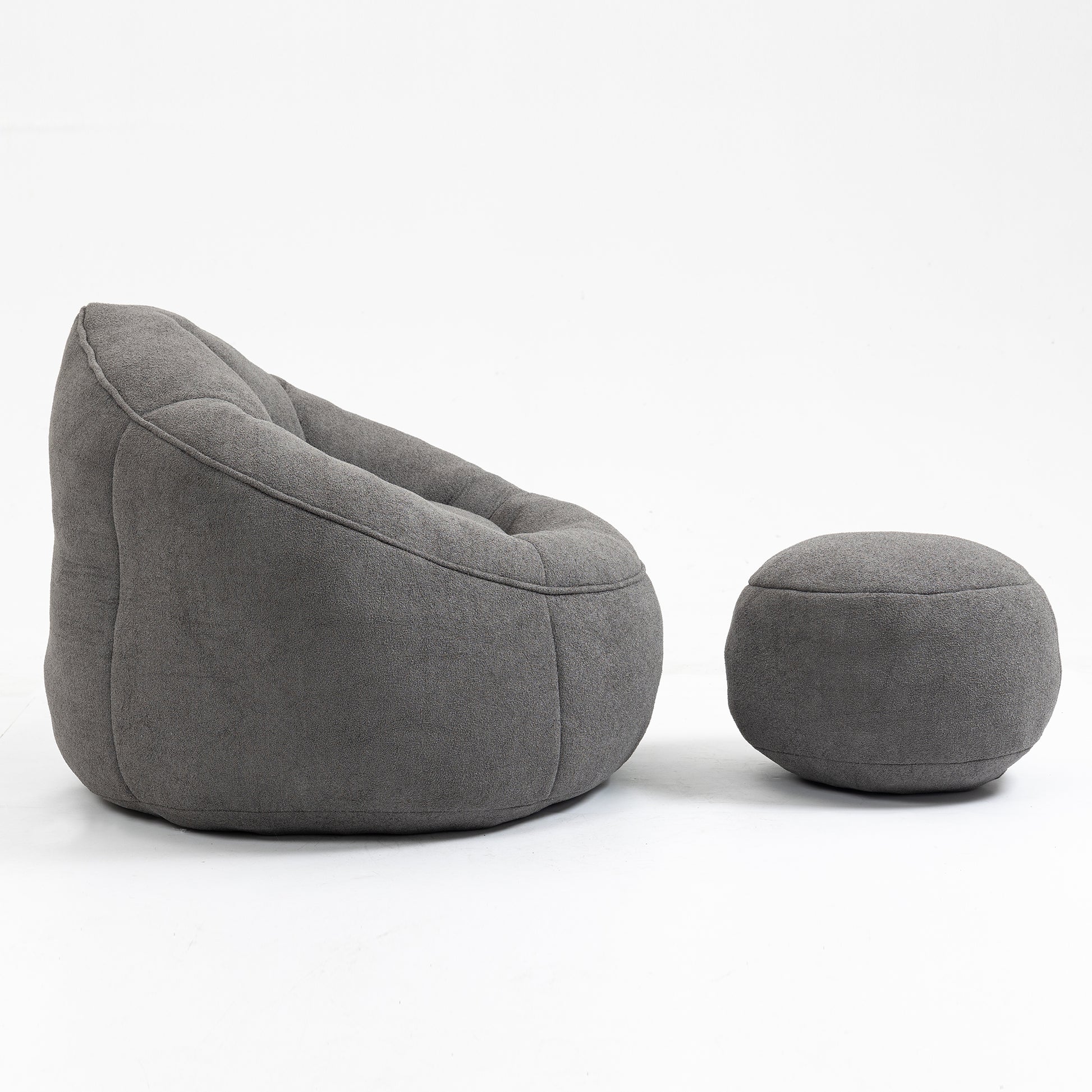 Dark grey tufted bean bag chair and matching ottoman made from soft fabric