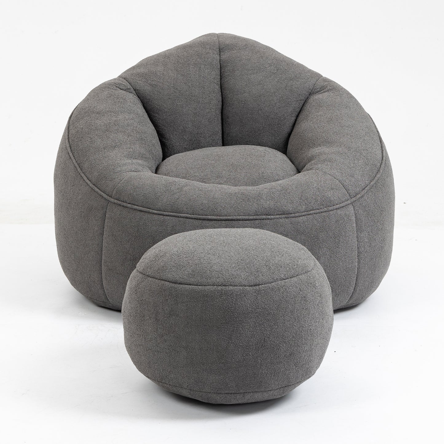 Comfortable dark grey fabric bean bag chair with matching ottoman for relaxation