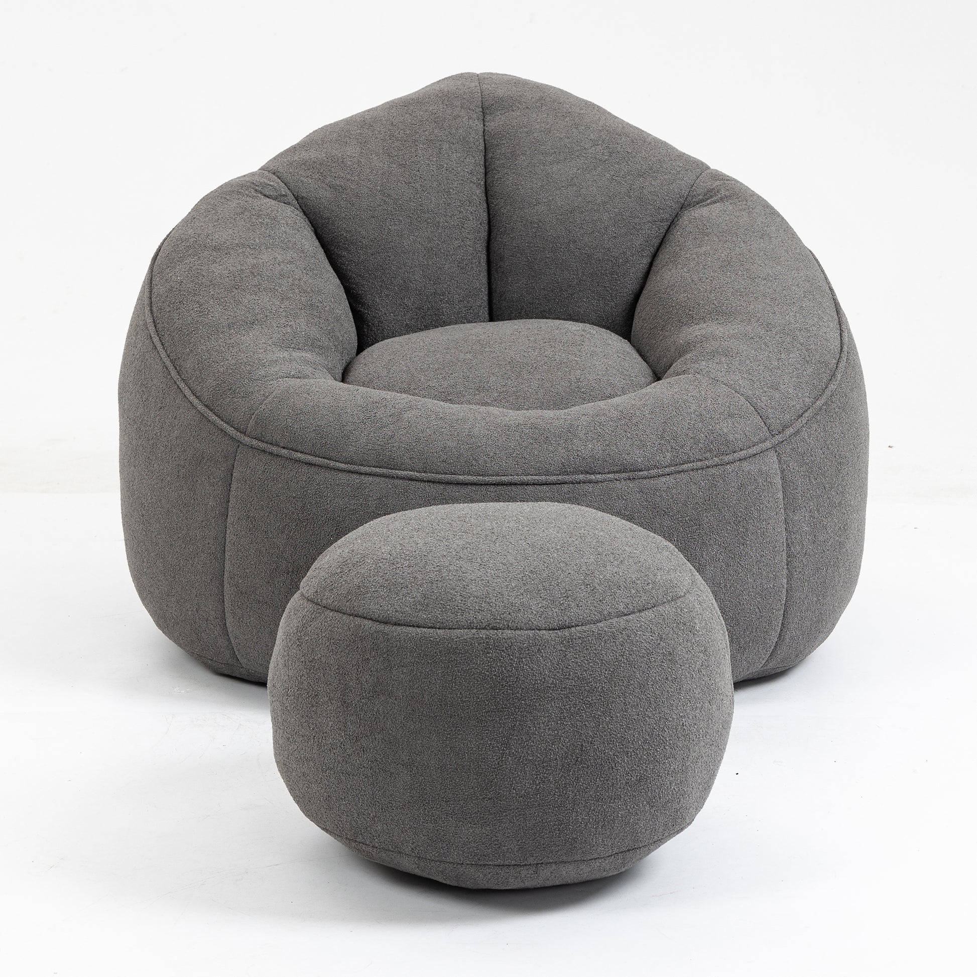 Comfortable dark grey fabric bean bag chair with matching ottoman for relaxation