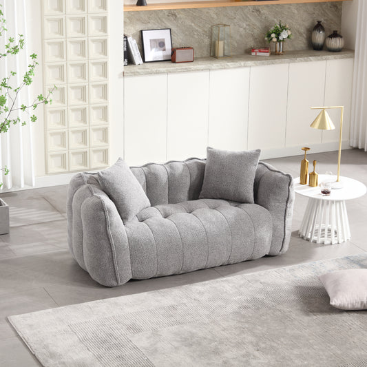 Plush grey boucl fabric loveseat with button tufting and ribbed detailing