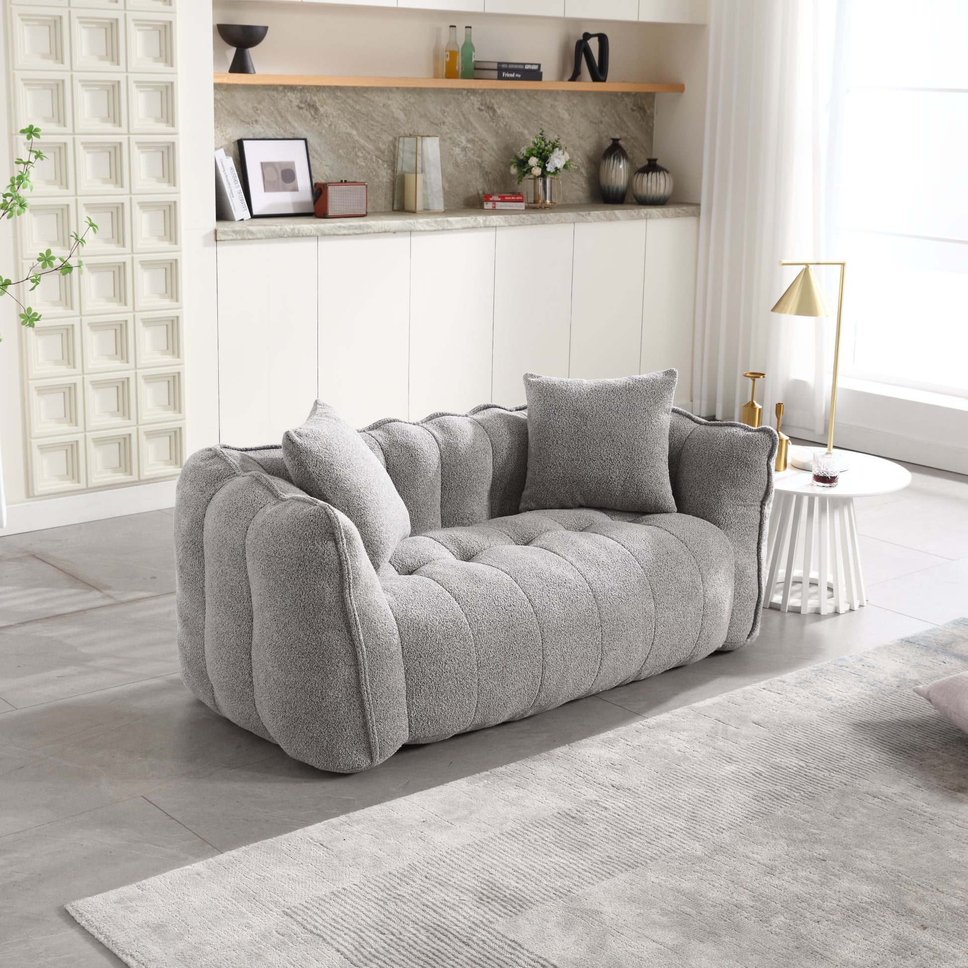 Plush grey boucle sofa with deep tufting perfect for a modern living room
