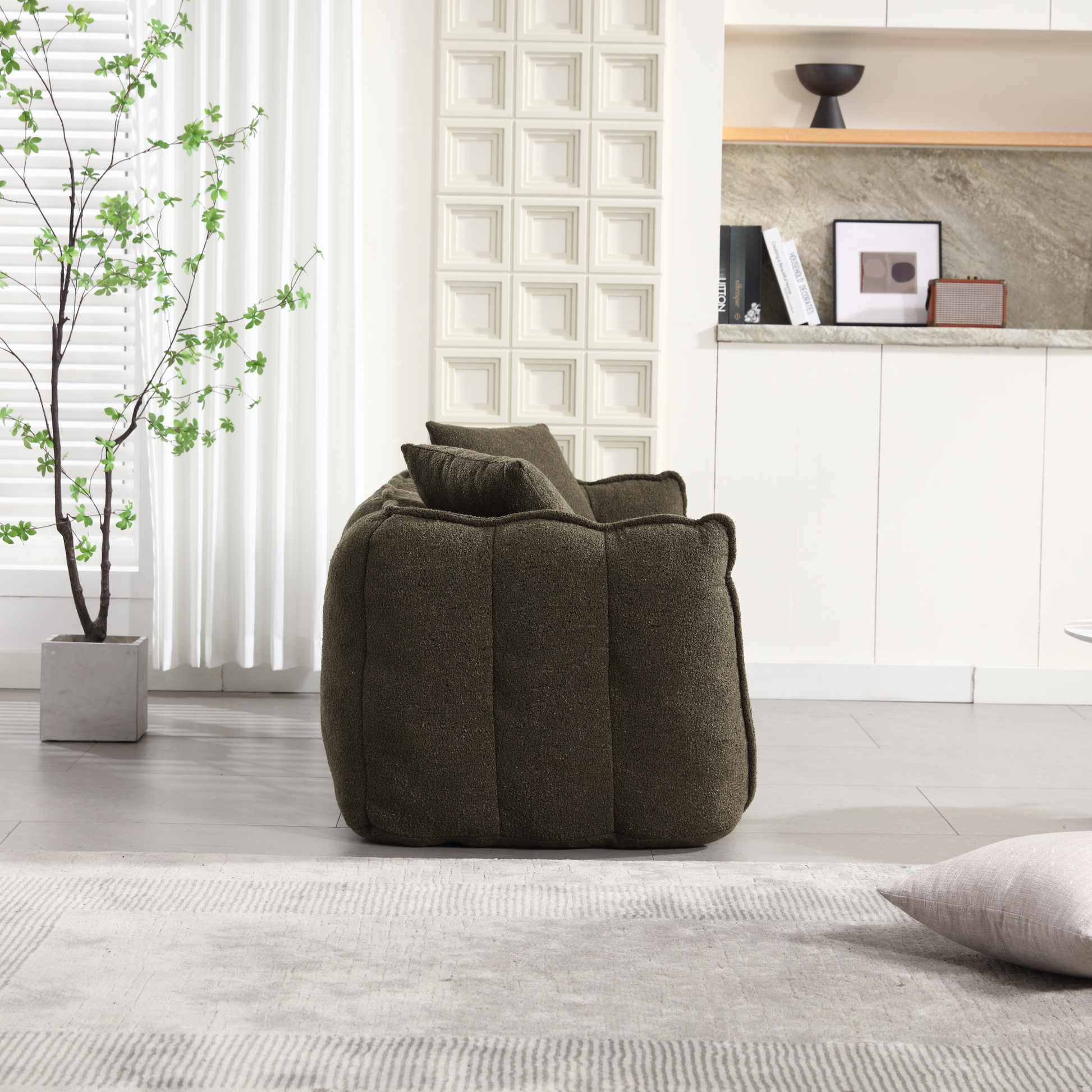 Plush olive green armchair with textured fabric and matching lumbar pillow modern living room