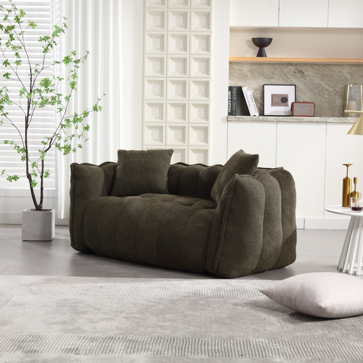 Dark olive boucle armchair with plush tufting and matching throw pillows