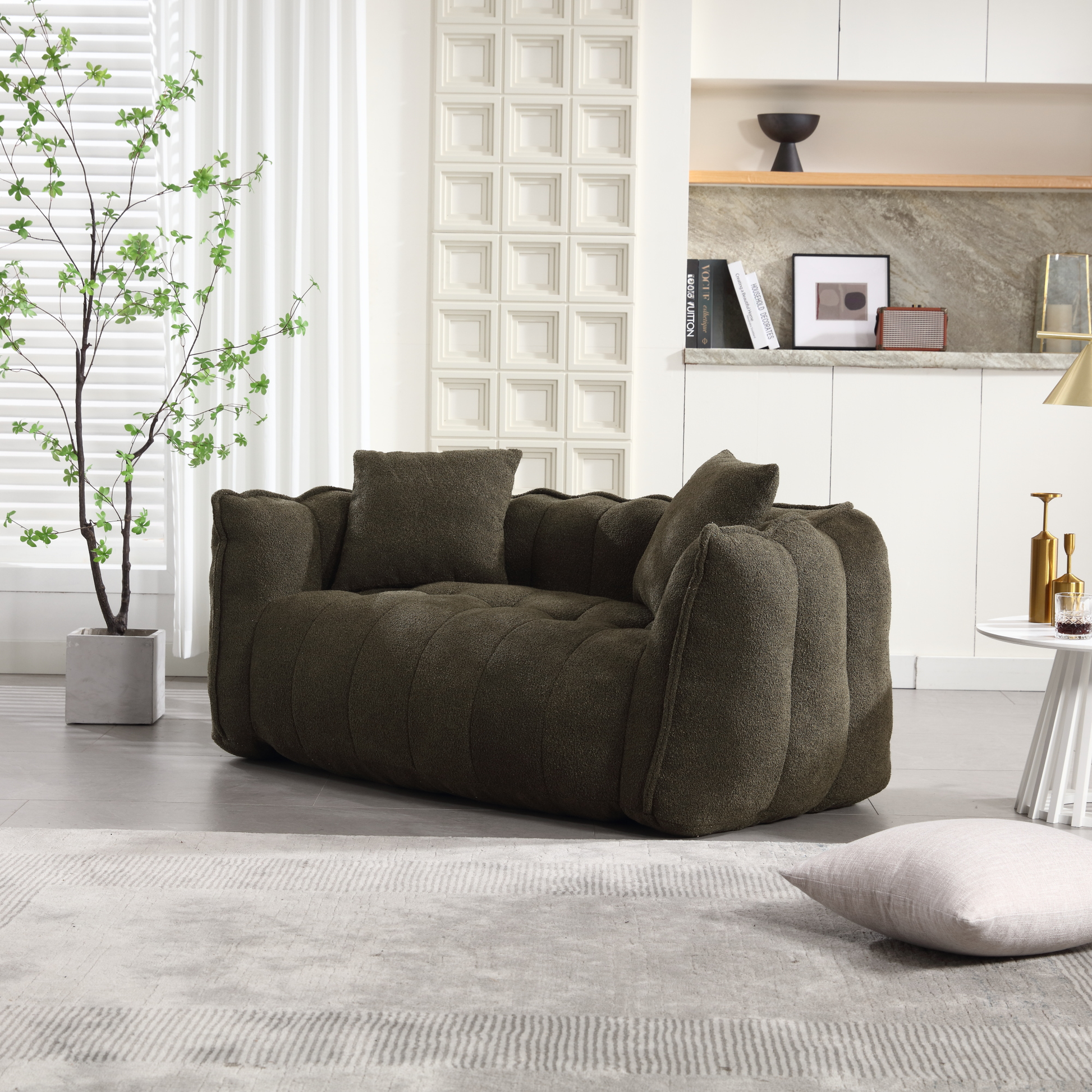 Dark olive boucle armchair with plush tufting and matching throw pillows