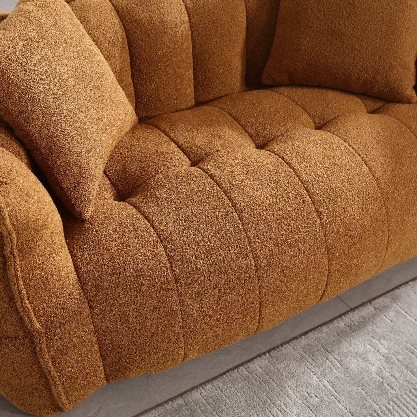 Brown boucle fabric sofa with tufted cushions and plush throw pillows