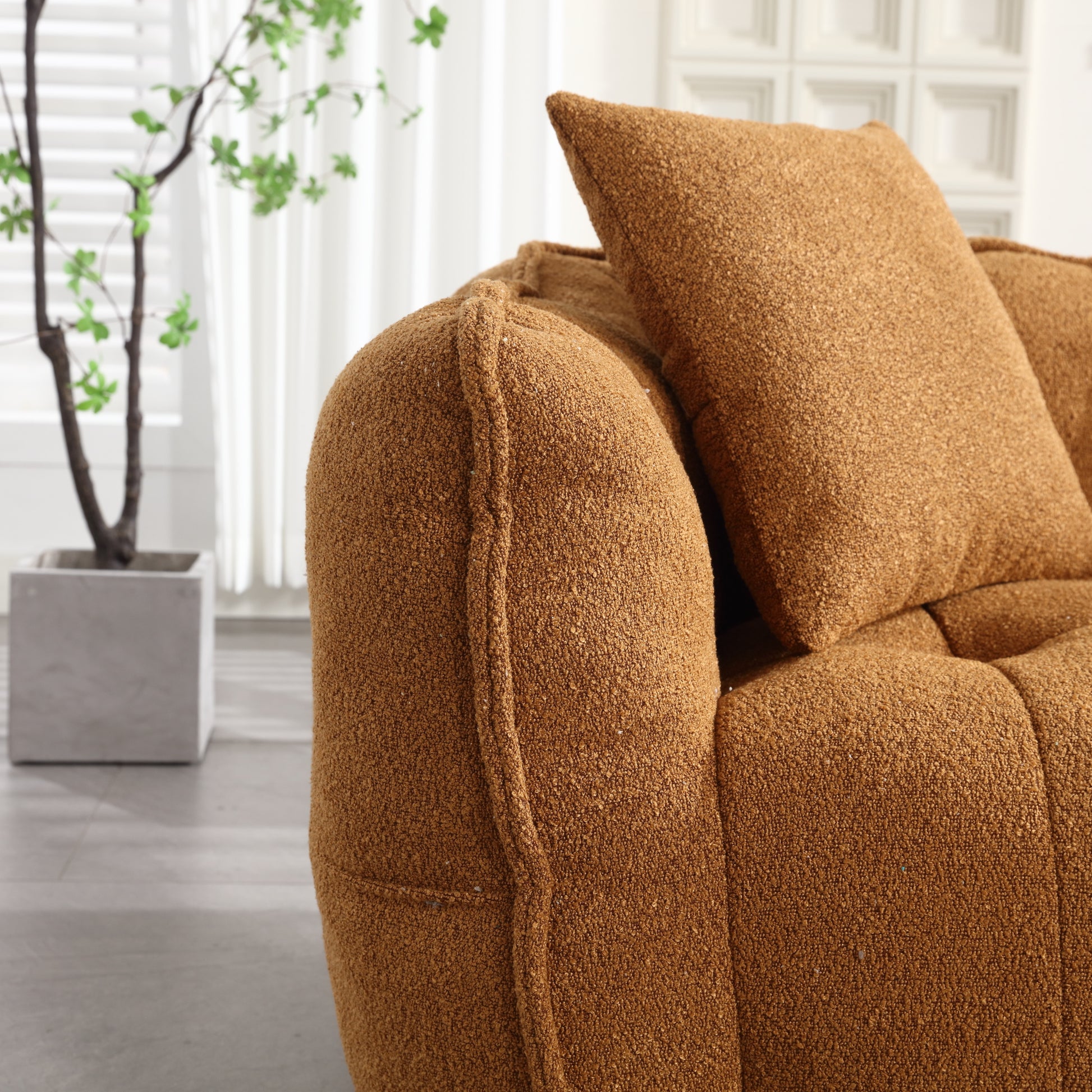 Cozy boucle fabric couch in a warm caramel color perfect for a modern living room