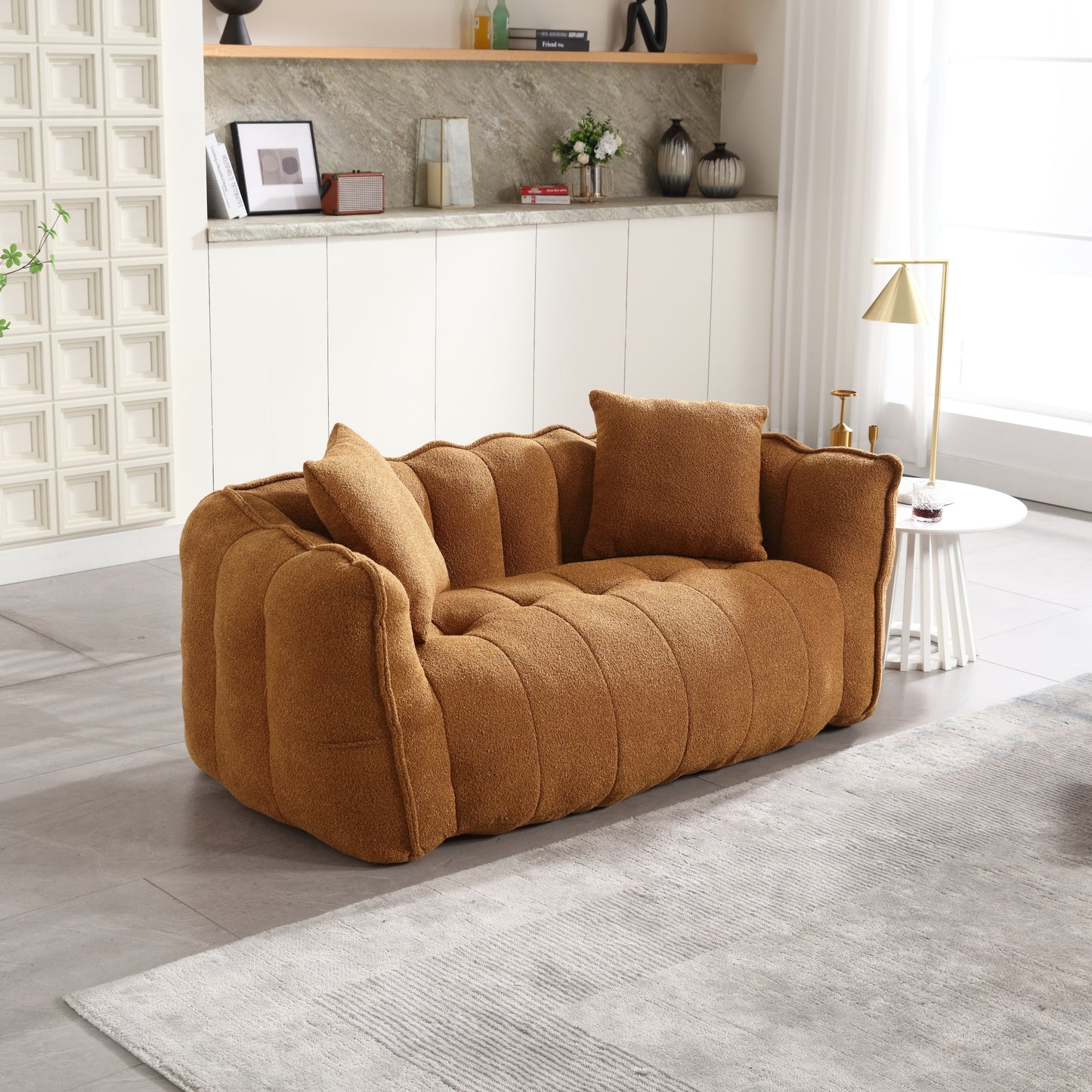 Plush caramel boucle fabric sofa with channel tufting and two throw pillows