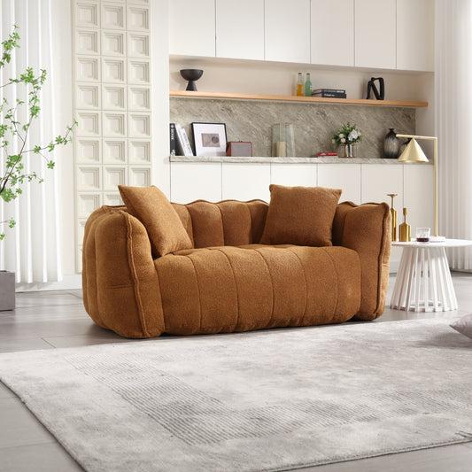 Textured brown boucle sofa with channel tufting and matching throw pillows