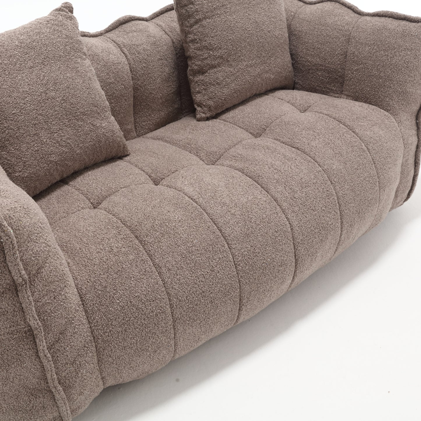 Plush taupe boucle fabric sofa with tufted seat and curved back perfect for modern living rooms