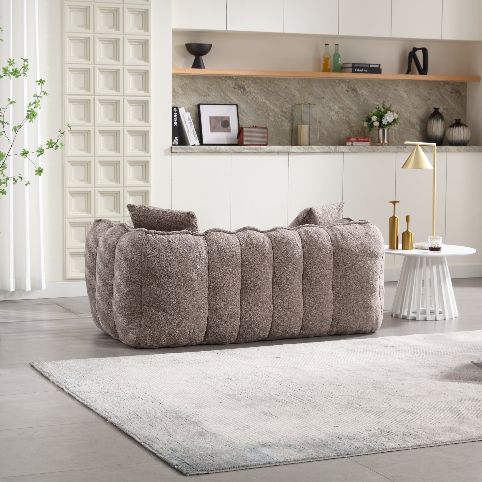 Plush taupe boucle sofa with channel tufting and modern design