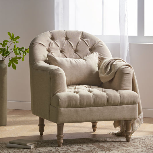 Tufted beige linen accent chair with rolled arms and decorative wooden legs