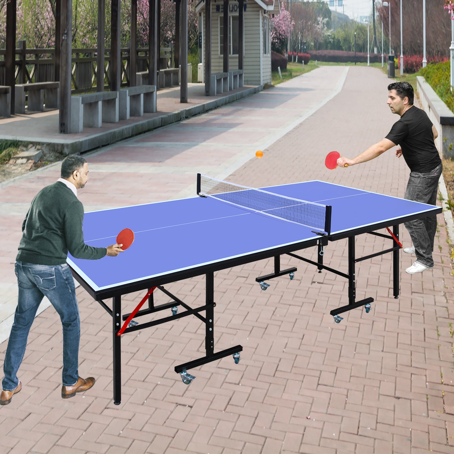 Blue folding ping pong table with wheels in an outdoor park setting