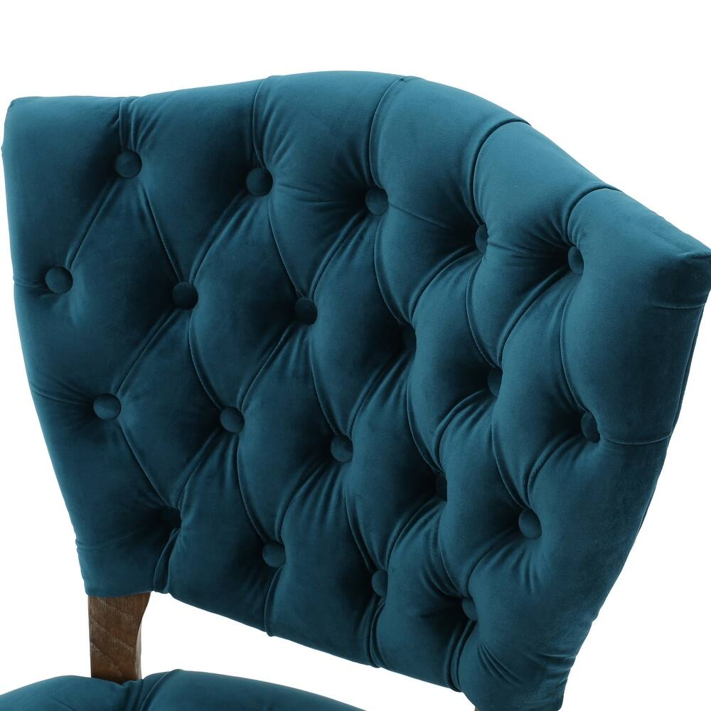 Deep teal velvet accent chair with diamond tufting and curved back