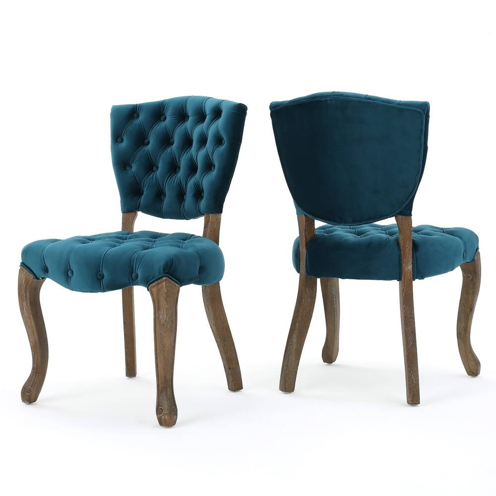 Teal velvet tufted dining chair with curved wooden legs and button detail
