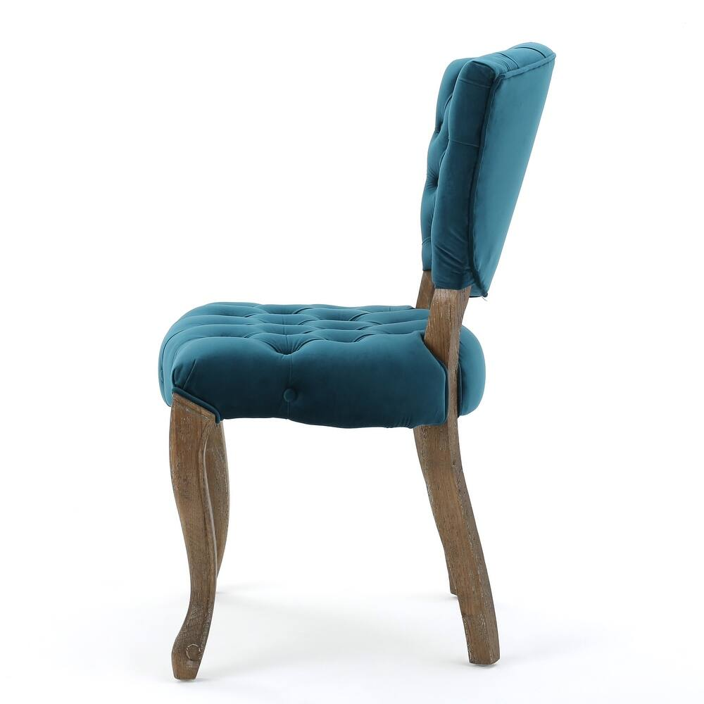 Teal velvet tufted dining chair with carved wooden legs