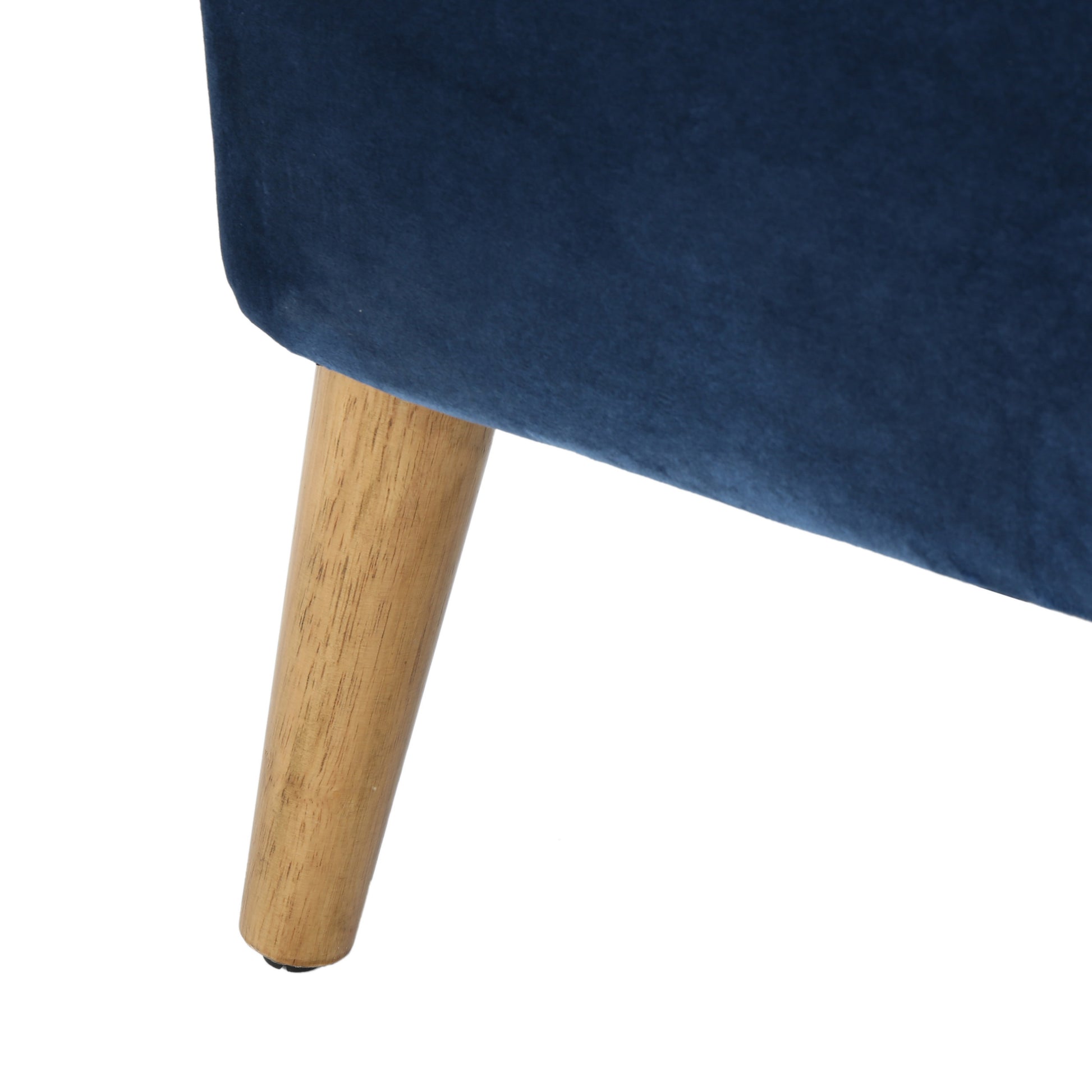 Deep navy velvet upholstery with a single tapered wooden leg