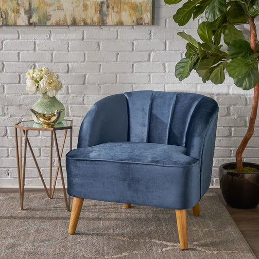 Navy velvet accent chair with fluted back and tapered wooden legs