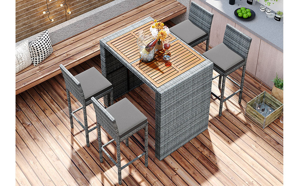 Gray wicker bar set with wooden tabletop and grey cushions perfect for outdoor entertaining