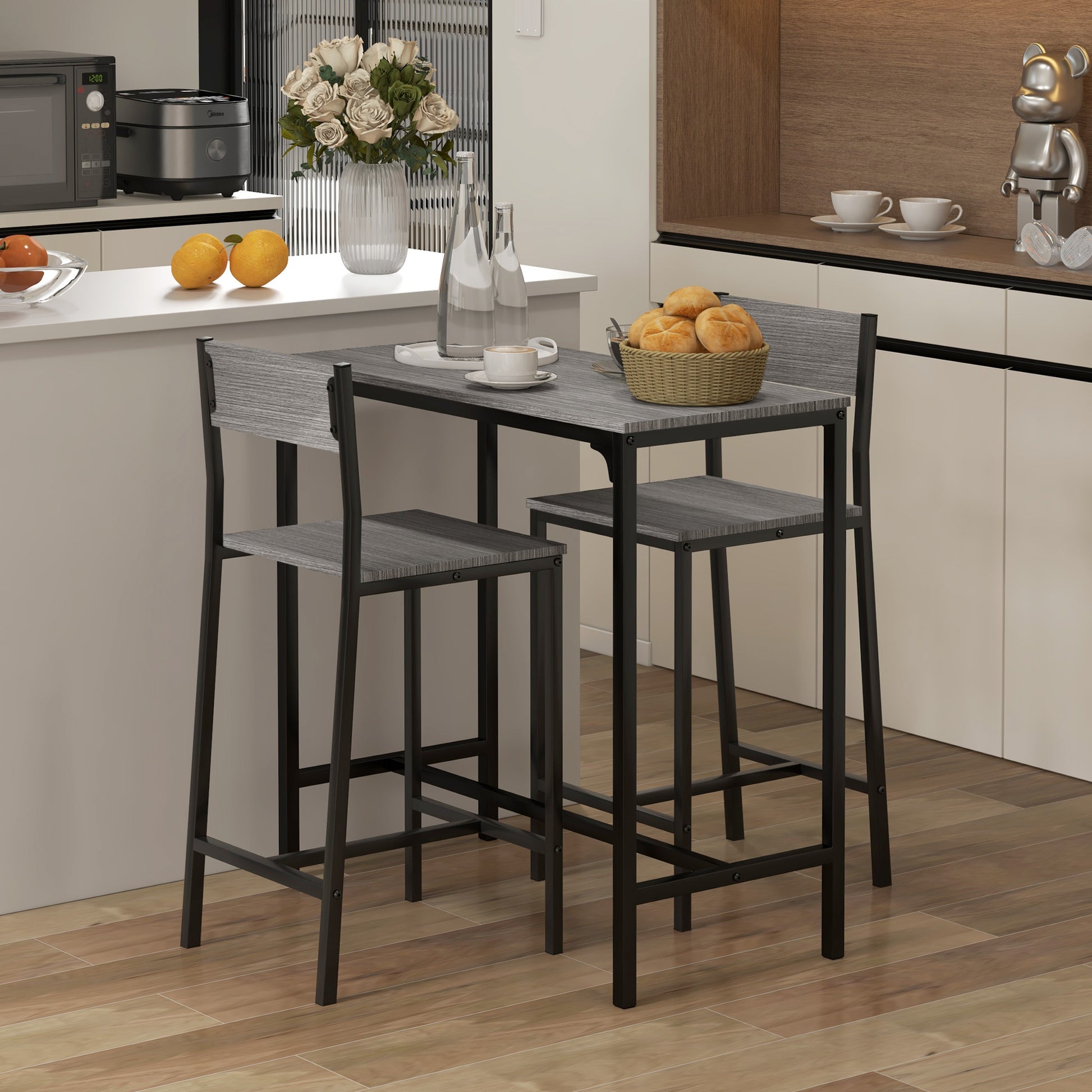 Gray wood counter height table with black metal frame and two matching stools