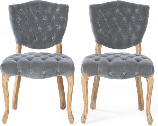 Tufted grey velvet dining chair with ornate wooden legs perfect for elegant interiors