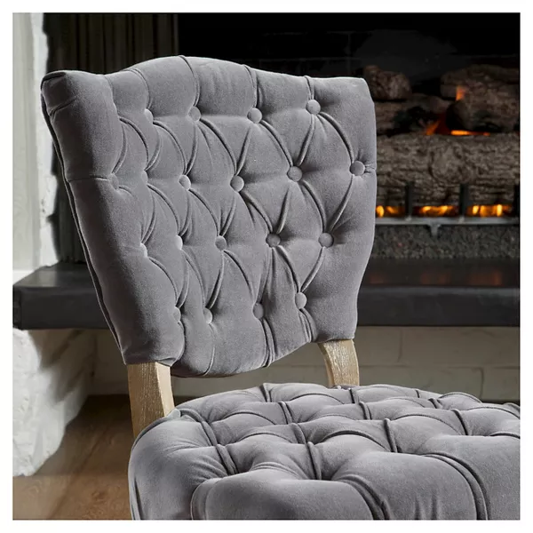 Gray velvet accent chair with tufted back perfect for living rooms