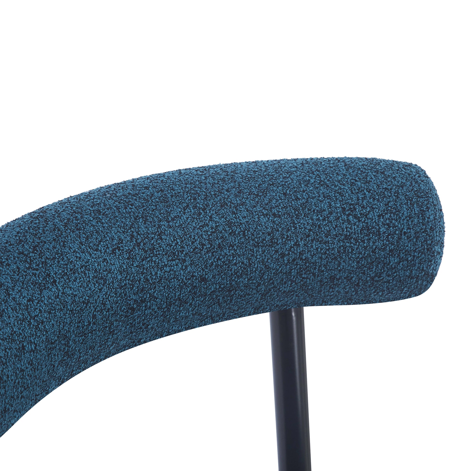Closeup of a textured teal fabric chair back with a black metal support