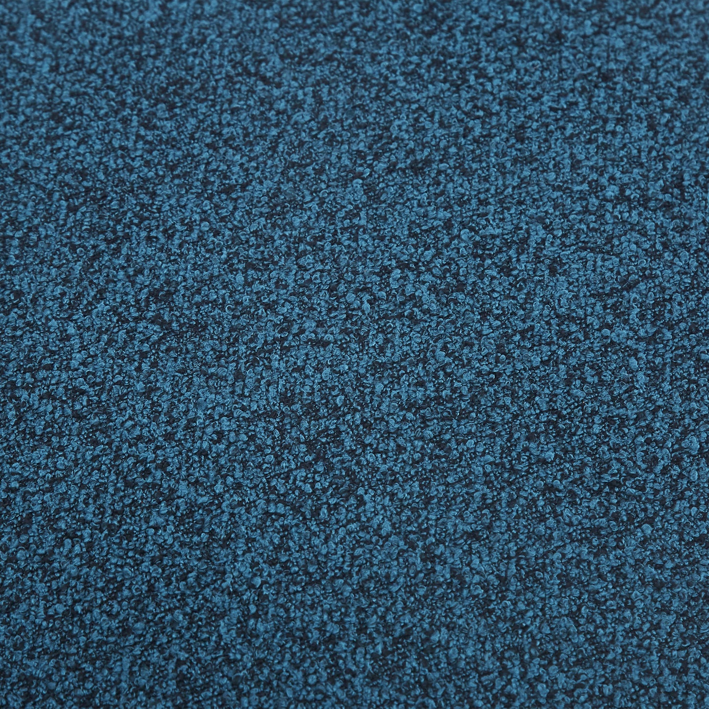 Closeup of textured dark teal boucle fabric ideal for upholstery