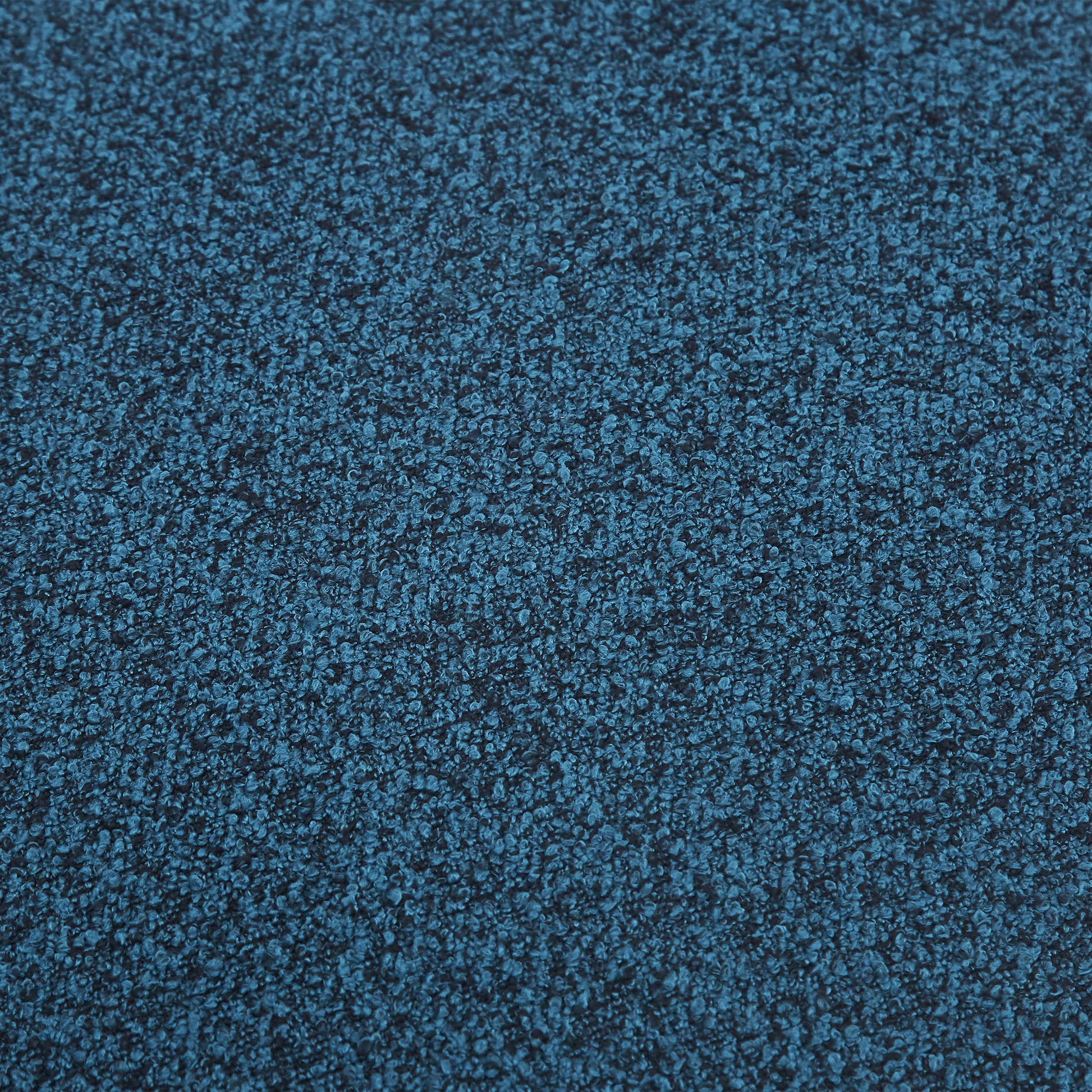 Closeup of textured dark teal boucle fabric ideal for upholstery